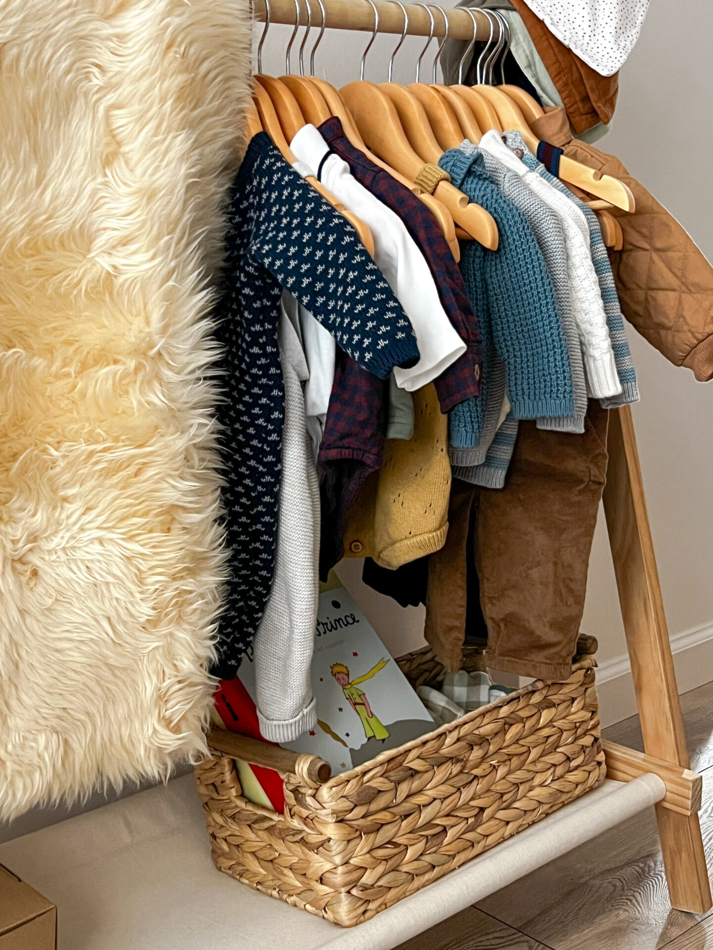 Displayed organic baby clothes and sheepskin rug